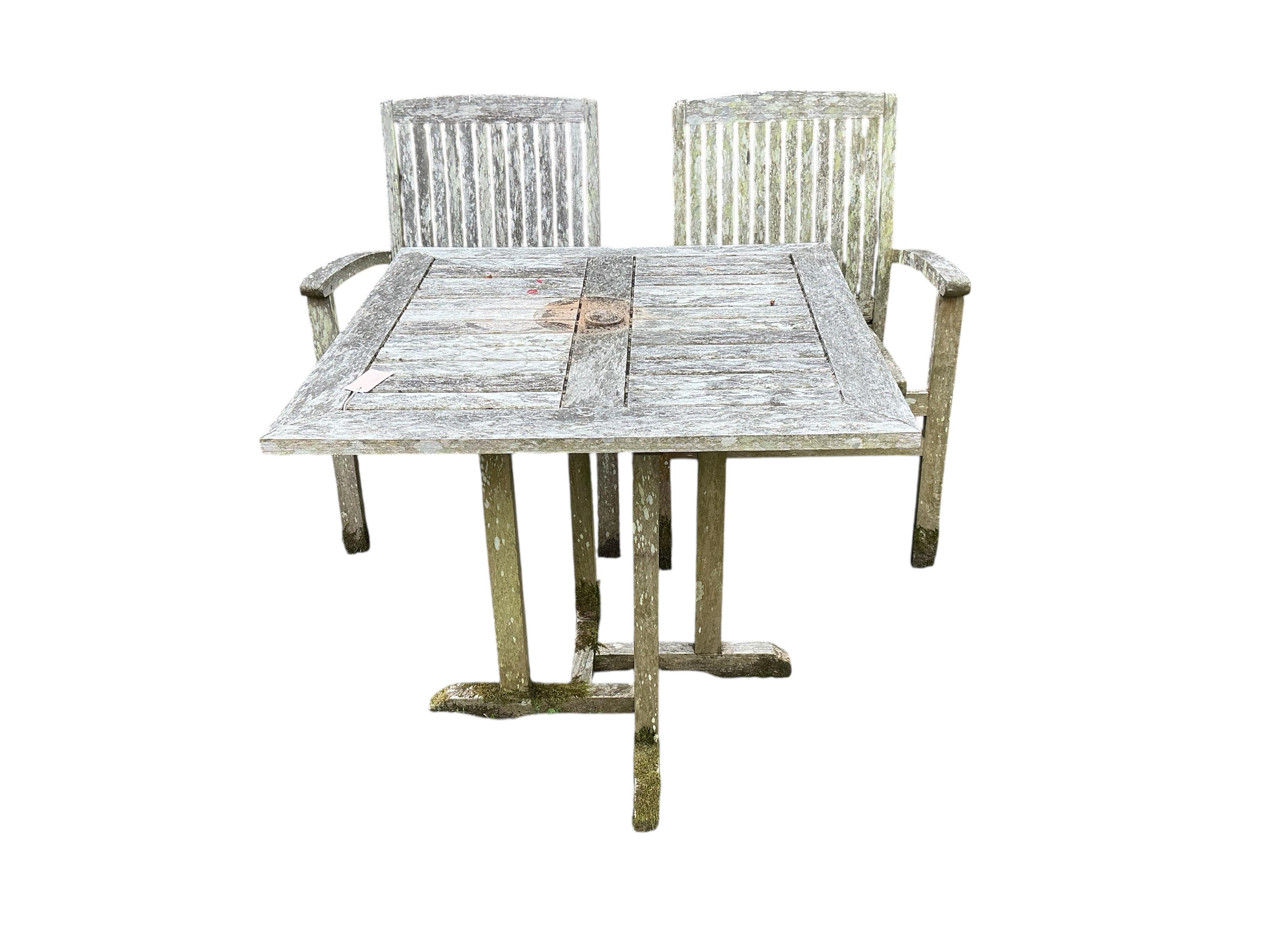 A Lindsey weathered teak square garden table, width 79cm, height 73cm and two chairs